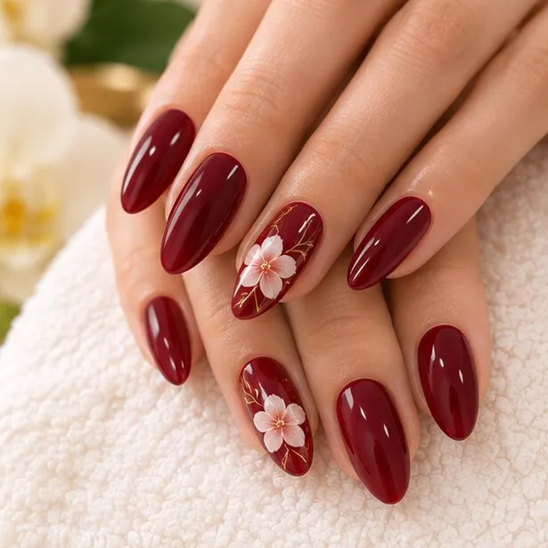 Burgundy nails with a flower accent